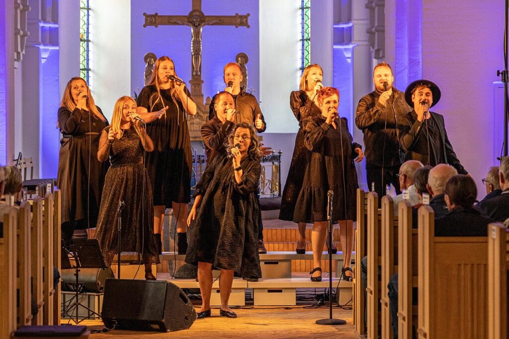 Church worship team leading a service broadcast by livestream and phone